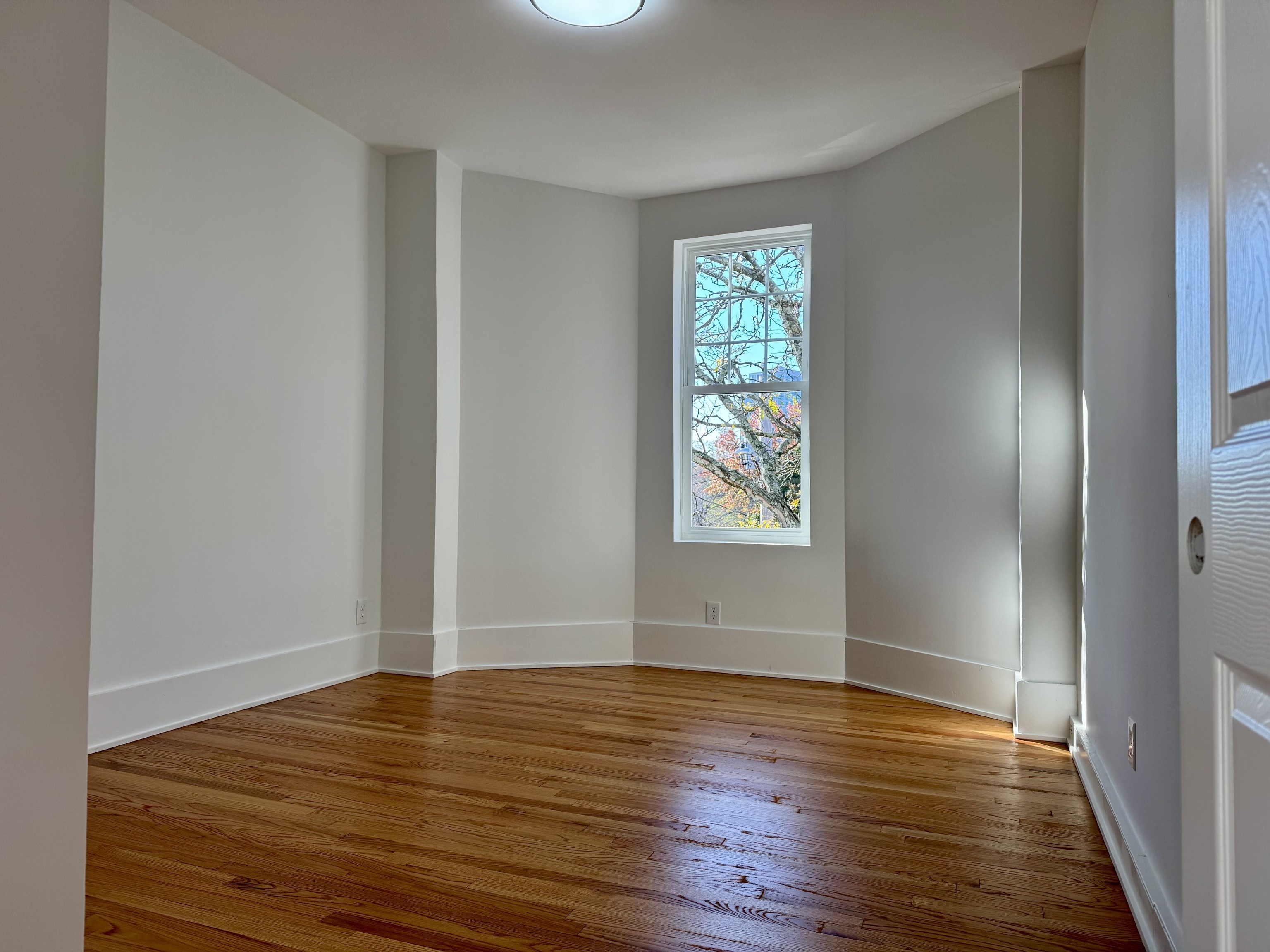 177 Chestnut Street, Unit 2R New Haven, CT 06511 - Photo 4 of 12 wooden floor in an empty room with a window