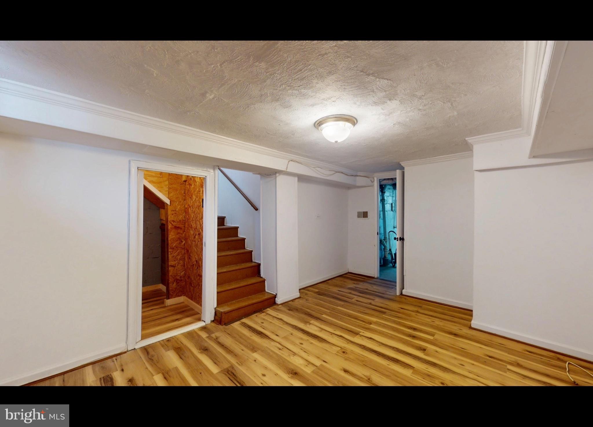 944 1st Street Brooklyn, MD 21225 - Photo 13 of 17 Spacious basement with warm wood floors.