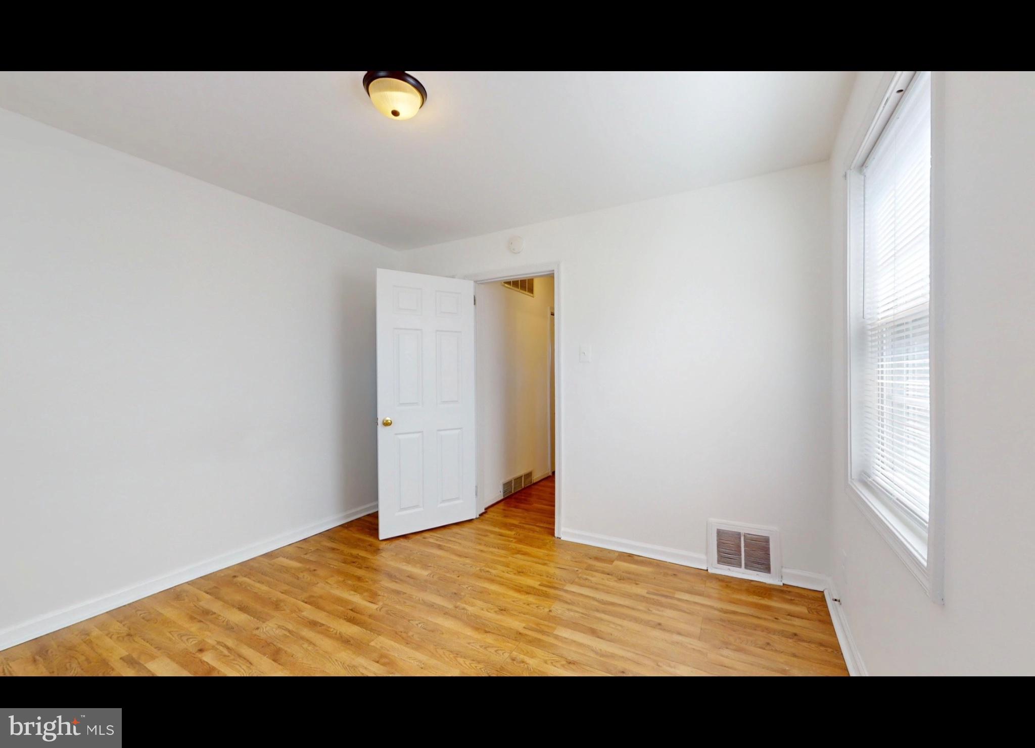 944 1st Street Brooklyn, MD 21225 - Photo 8 of 17 Bright and airy room with hardwood floors.