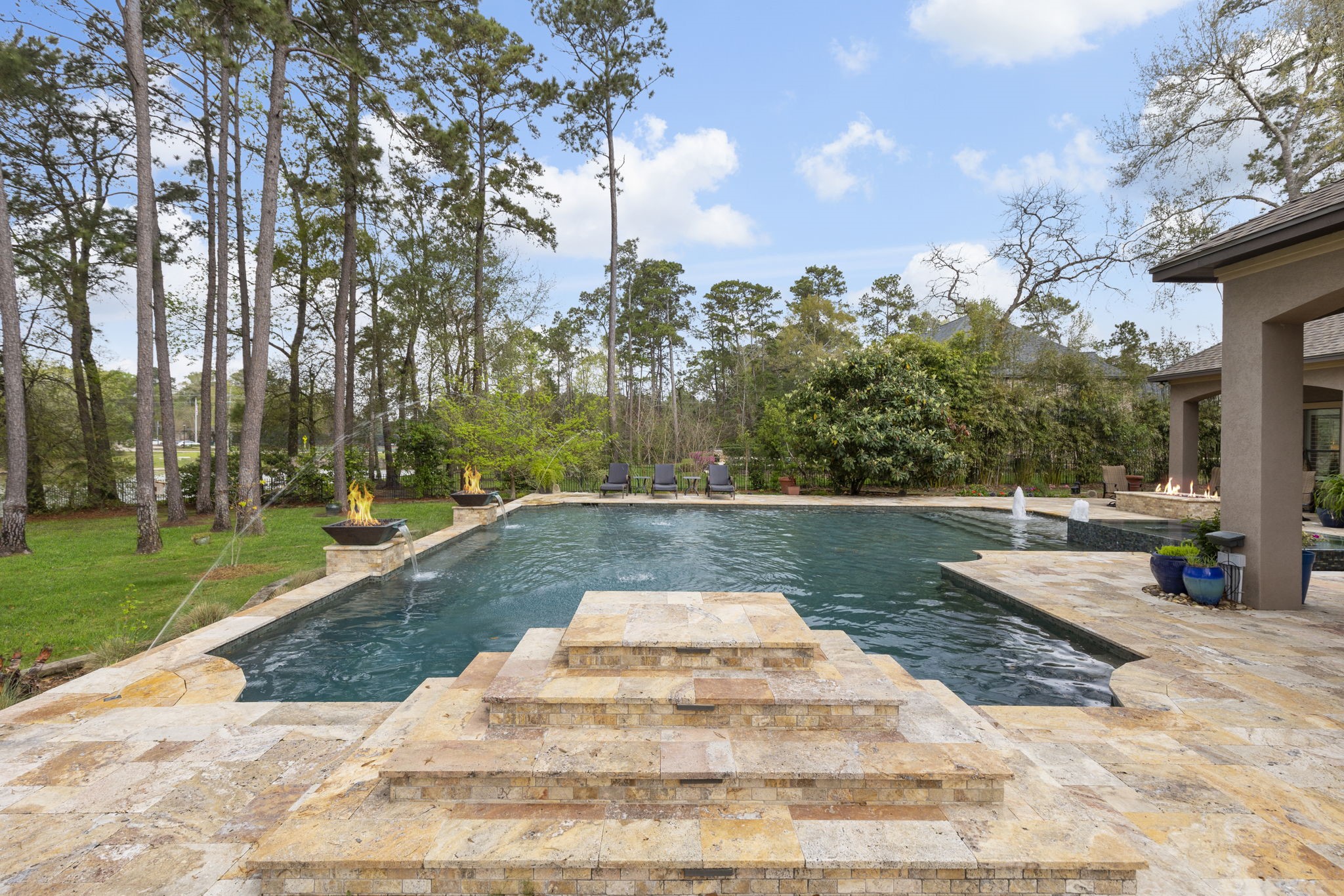 28227 KAILEES Court Spring, TX 77386 - Photo 37 of 48 Impressive PebbleTec pool with 9' depth featuring fire/water bowls, bubblers, deck jets, a raised jump rock - a favorite with kids, plus poolside rock speakers! Designed for versatility with saltwater or chlorine operation; pool heater replaced in 2025.