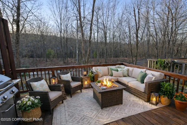 a outdoor living room with furniture and wooden floor