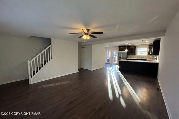a view of a living room with wooden floor