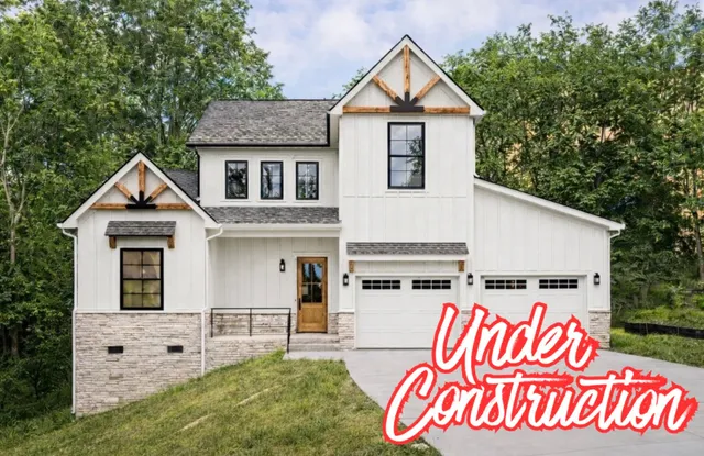 a view of street and sign in front of house