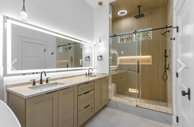 a bathroom with a shower sink vanity granite and mirror