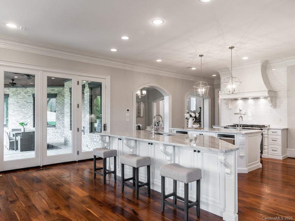404 Eagle Bend Drive Waxhaw, NC 28173 - Photo 21 of 46 a dining room with kitchen island stainless steel appliances furniture a large window and kitchen view