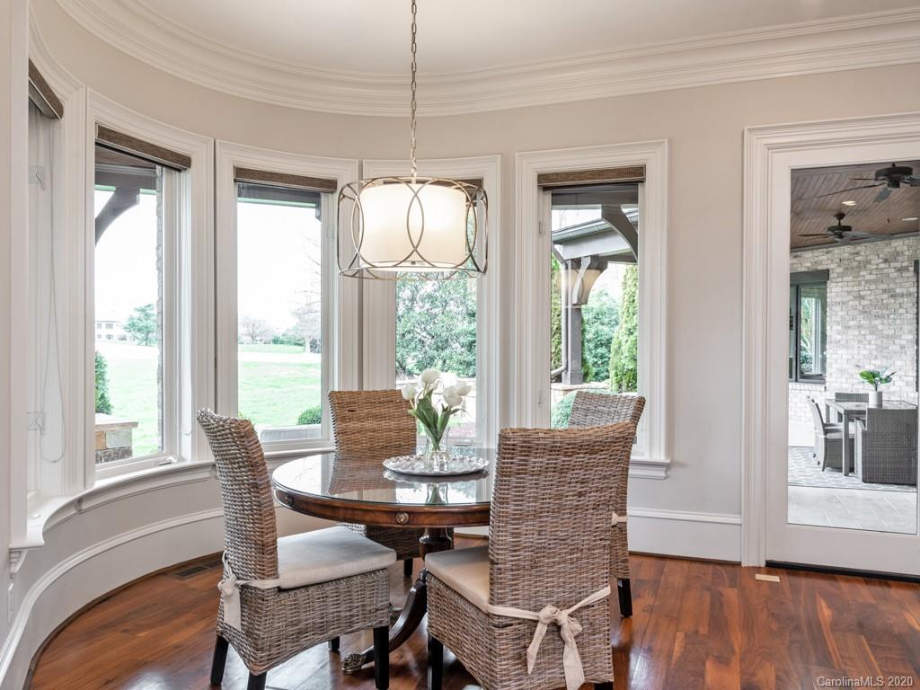 404 Eagle Bend Drive Waxhaw, NC 28173 - Photo 22 of 46 a dining room with furniture a chandelier and wooden floor