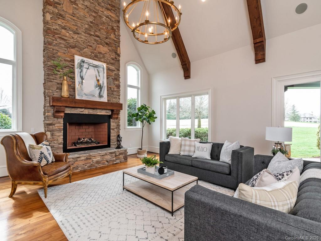 404 Eagle Bend Drive Waxhaw, NC 28173 - Photo 26 of 46 a living room with furniture a fireplace and a large window