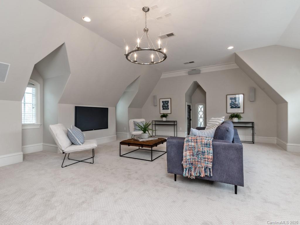 404 Eagle Bend Drive Waxhaw, NC 28173 - Photo 36 of 46 a living room with furniture chandelier and a flat screen tv