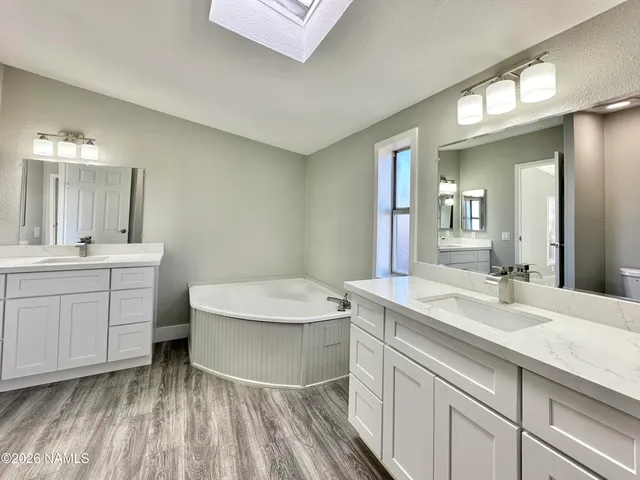 a bathroom with a sink a toilet and mirror