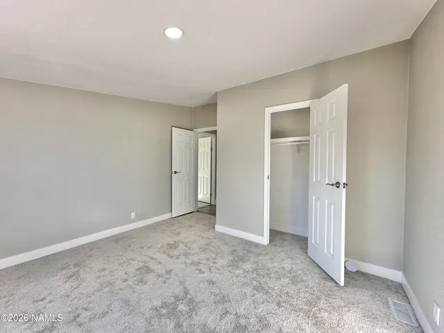 a view of an empty room and closet area