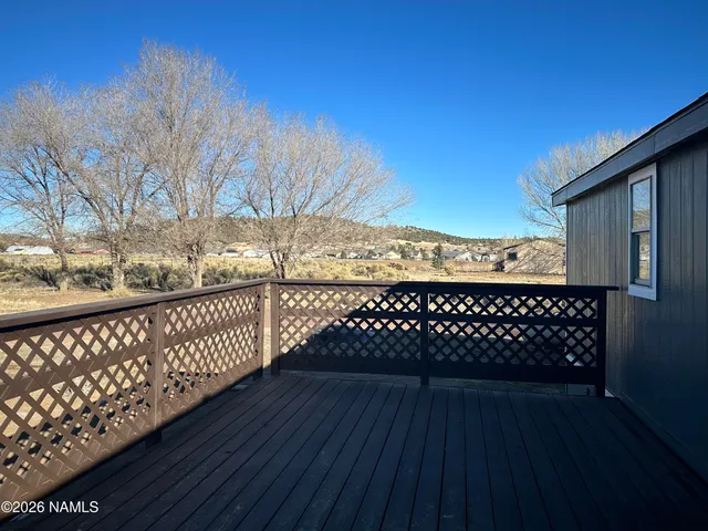 a view of a balcony with wooden fence