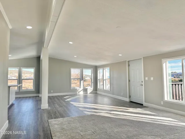 wooden floor with windows and chandelier in a room