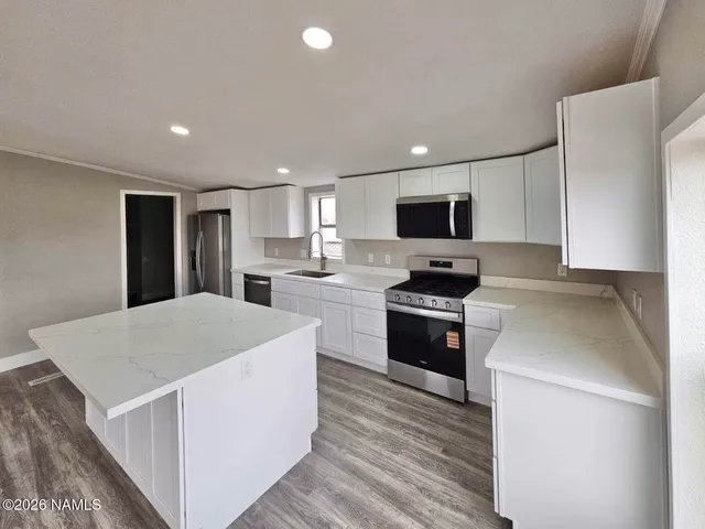 a kitchen with sink a microwave and refrigerator