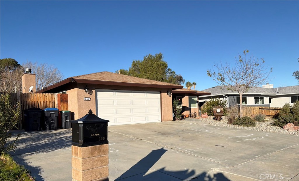 209 Kimberly Lane Ridgecrest, CA 93555 - Photo 3 of 62 a front view of a house with a yard