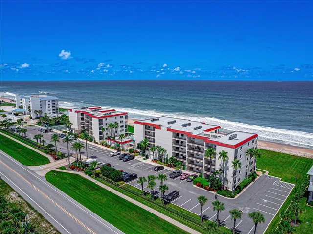 a view of a chairs and table in a backyard