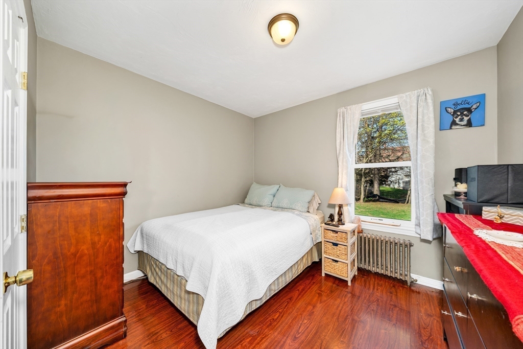 107 Apsley Street Hudson, MA 01749 - Photo 11 of 26 a bedroom with a bed and a flat screen tv