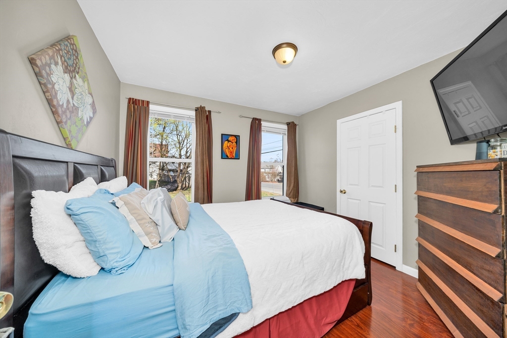 107 Apsley Street Hudson, MA 01749 - Photo 12 of 26 a bedroom with a bed and wooden floor