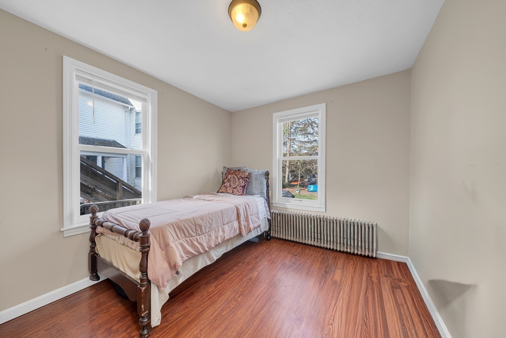 107 Apsley Street Hudson, MA 01749 - Photo 13 of 26 a bedroom with a bed and a window