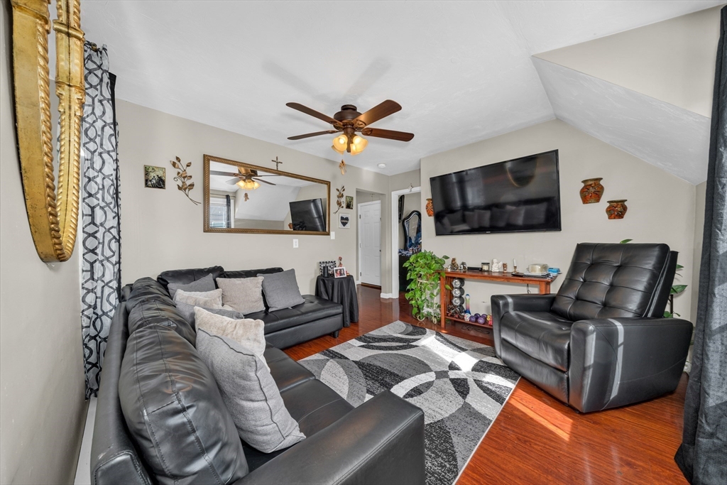 107 Apsley Street Hudson, MA 01749 - Photo 15 of 26 a living room with furniture and a flat screen tv