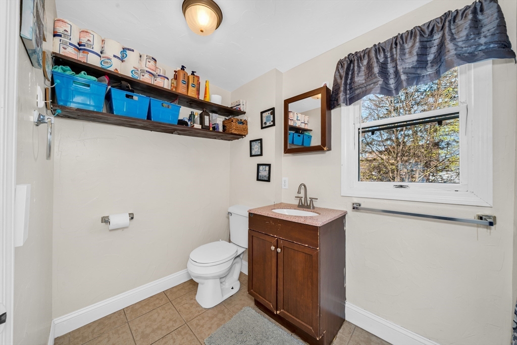 107 Apsley Street Hudson, MA 01749 - Photo 19 of 26 a bathroom with a toilet a sink and a mirror