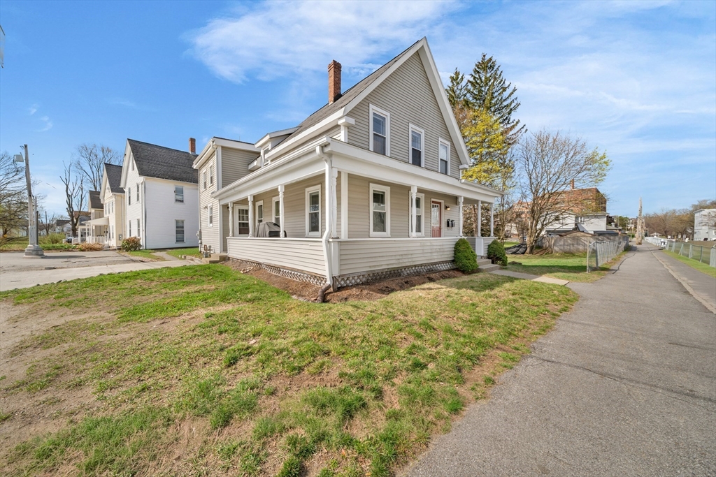 107 Apsley Street Hudson, MA 01749 - Photo 2 of 26 a front view of a house with a garden and yard