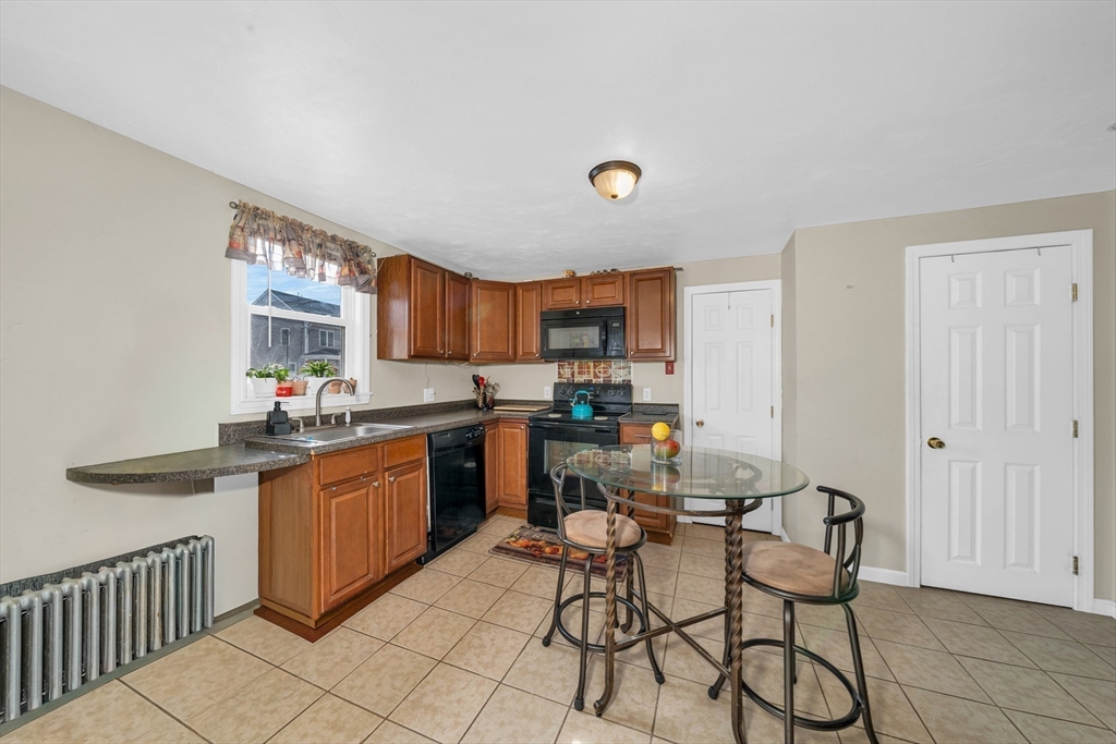 107 Apsley Street Hudson, MA 01749 - Photo 5 of 26 a kitchen with granite countertop a sink cabinets and stainless steel appliances