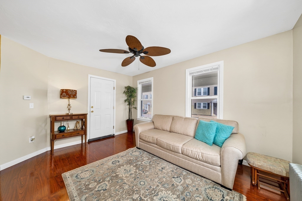 107 Apsley Street Hudson, MA 01749 - Photo 9 of 26 a living room with furniture wooden floor and a ceiling fan