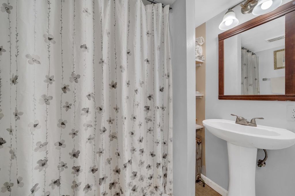 107 Apsley Street Hudson, MA 01749 - Photo 10 of 26 a bathroom with a sink a mirror and a shower