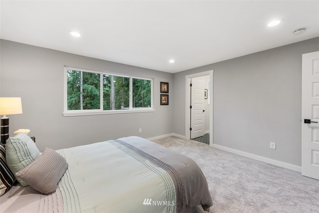 17015 1st Avenue Southeast Bothell, WA 98012 - Photo 14 of 30 a bedroom with a large bed and a window