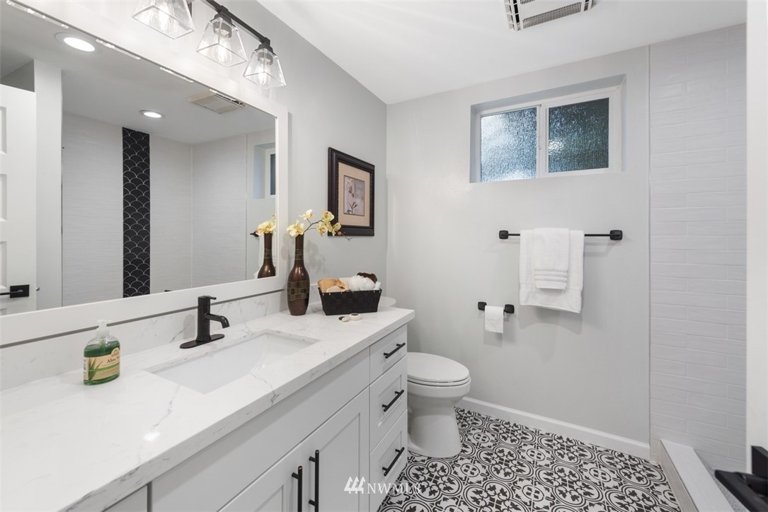 17015 1st Avenue Southeast Bothell, WA 98012 - Photo 22 of 30 a bathroom with a sink a toilet and shower