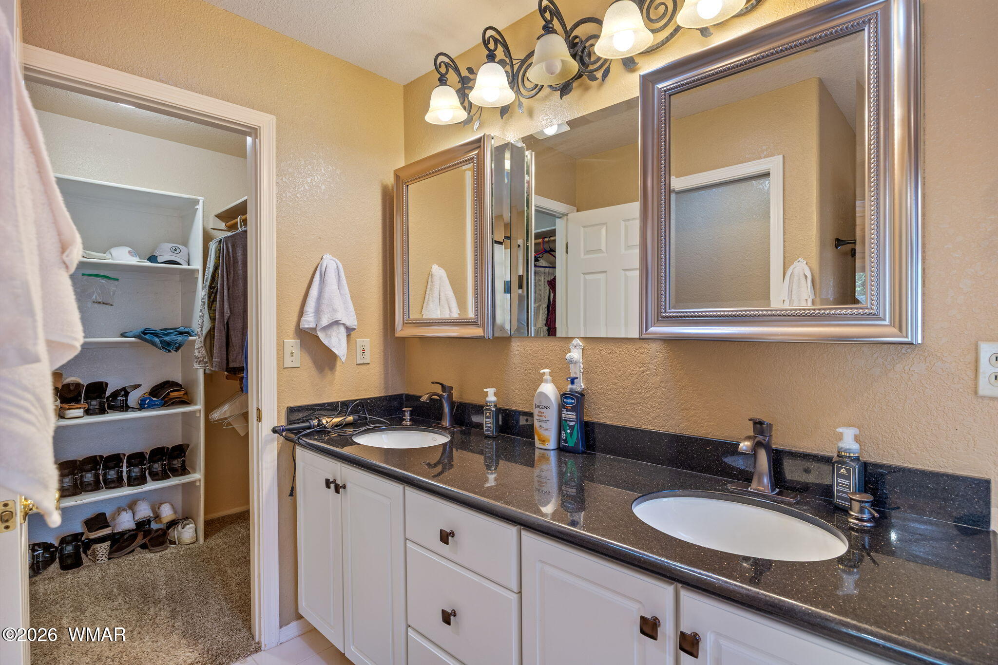 6735 Sunset Trail Pinetop, AZ 85935 - Photo 16 of 33 a bathroom with a double vanity sink and a mirror