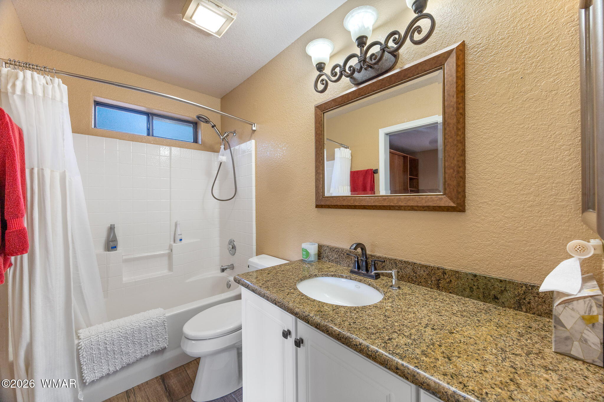 6735 Sunset Trail Pinetop, AZ 85935 - Photo 20 of 33 a bathroom with a granite countertop sink vanity mirror bathtub shower and toilet