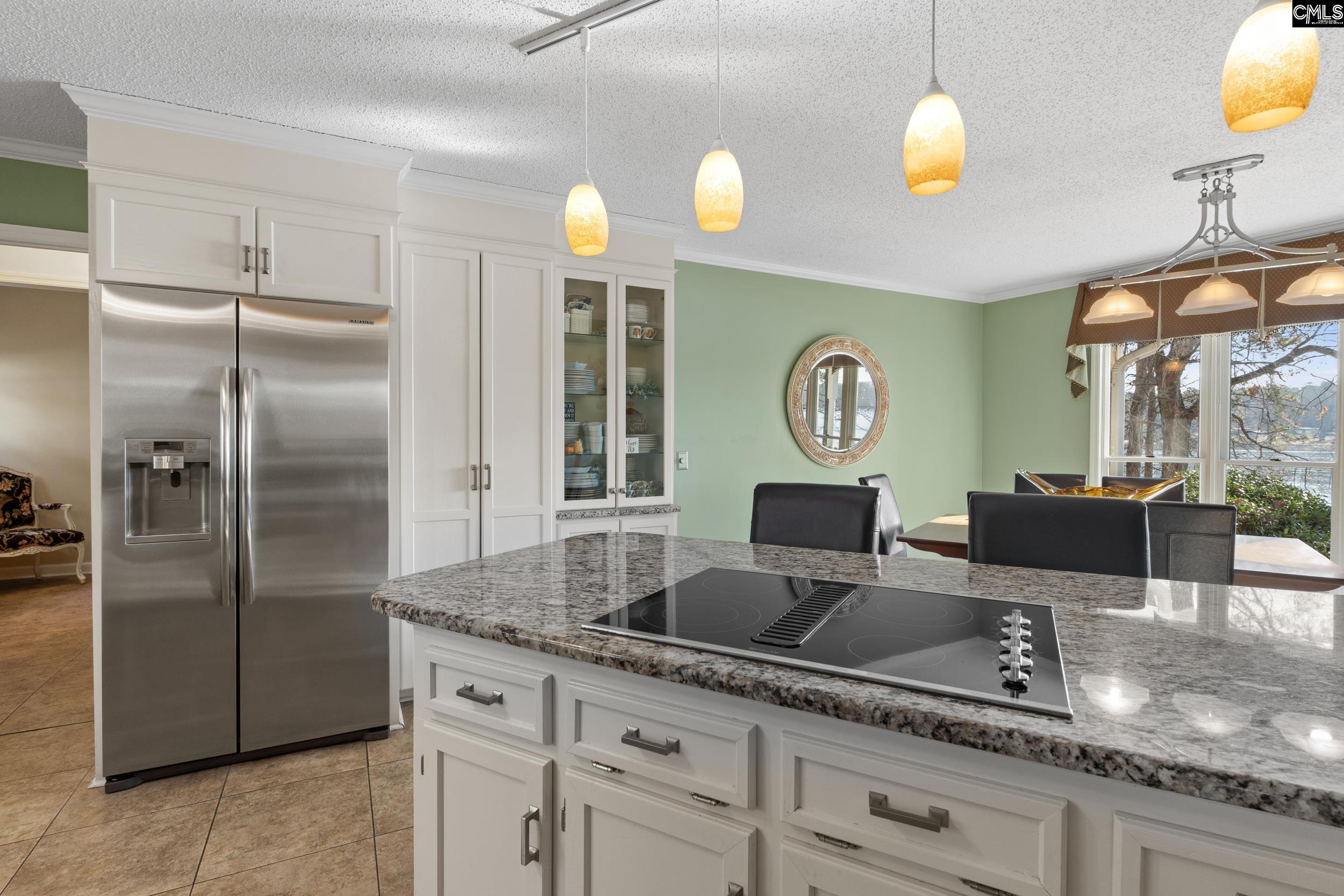 115 Rocky Ridge Road Leesville, SC 29070 - Photo 13 of 51 a kitchen with granite countertop a refrigerator a stove and a wooden floors