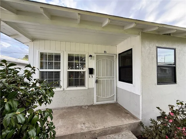 a view of front door and potted plants