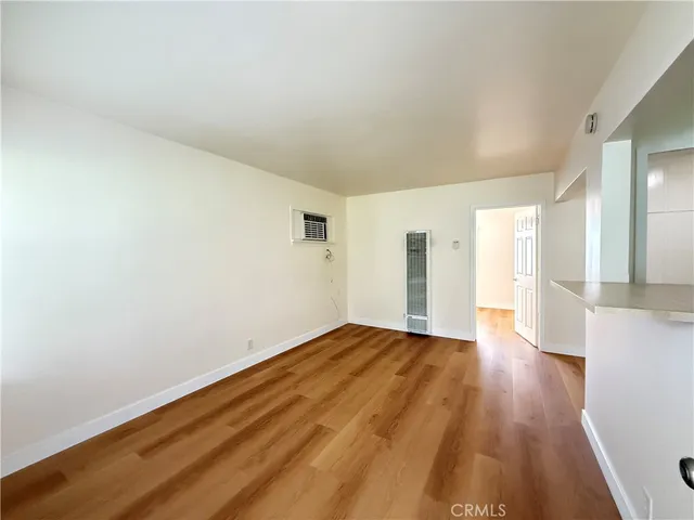 a view of an empty room and wooden floor