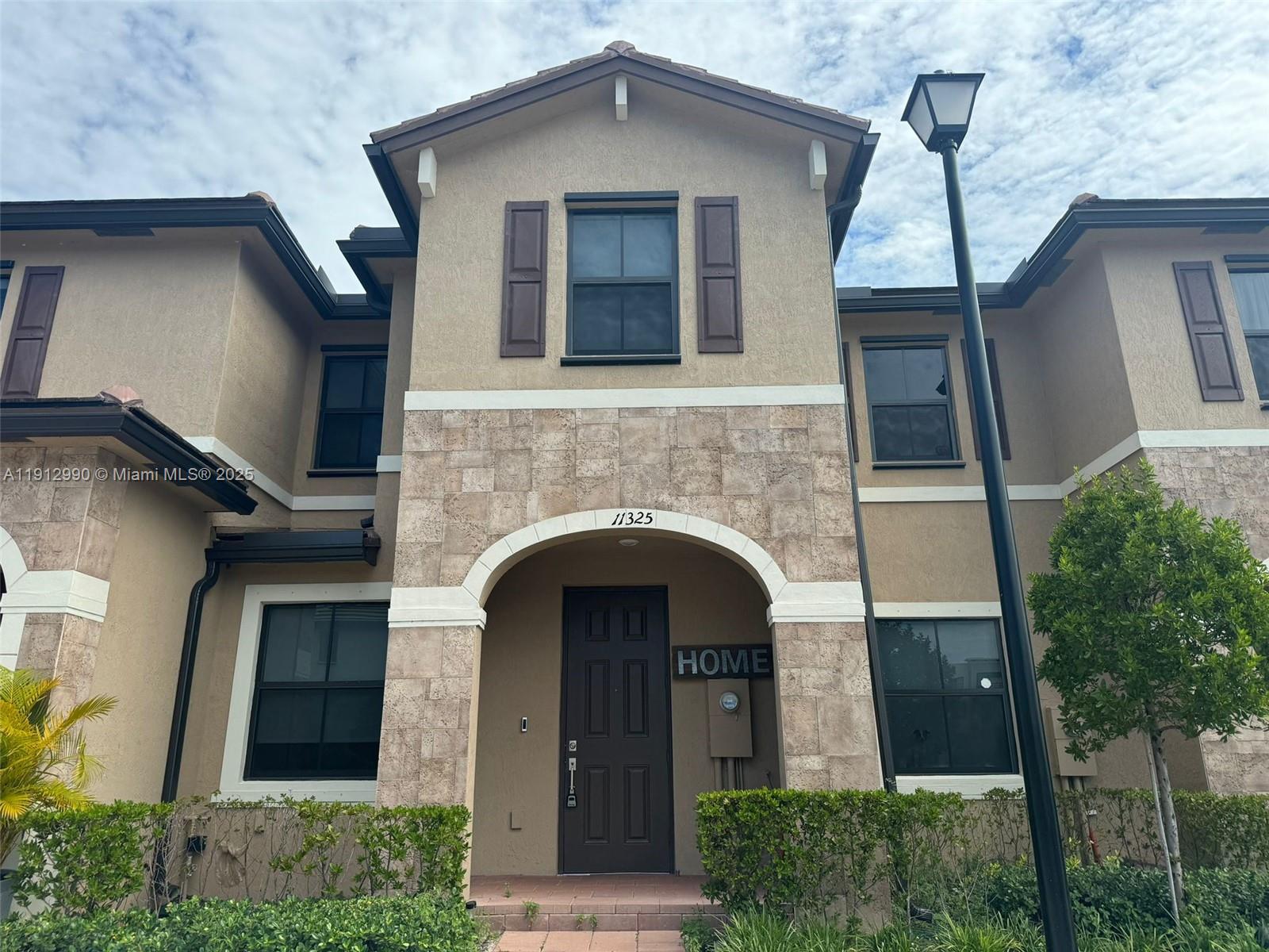 11325 West 34th Way Hialeah, FL 33018 - Photo 1 of 46 a front view of a house with plants