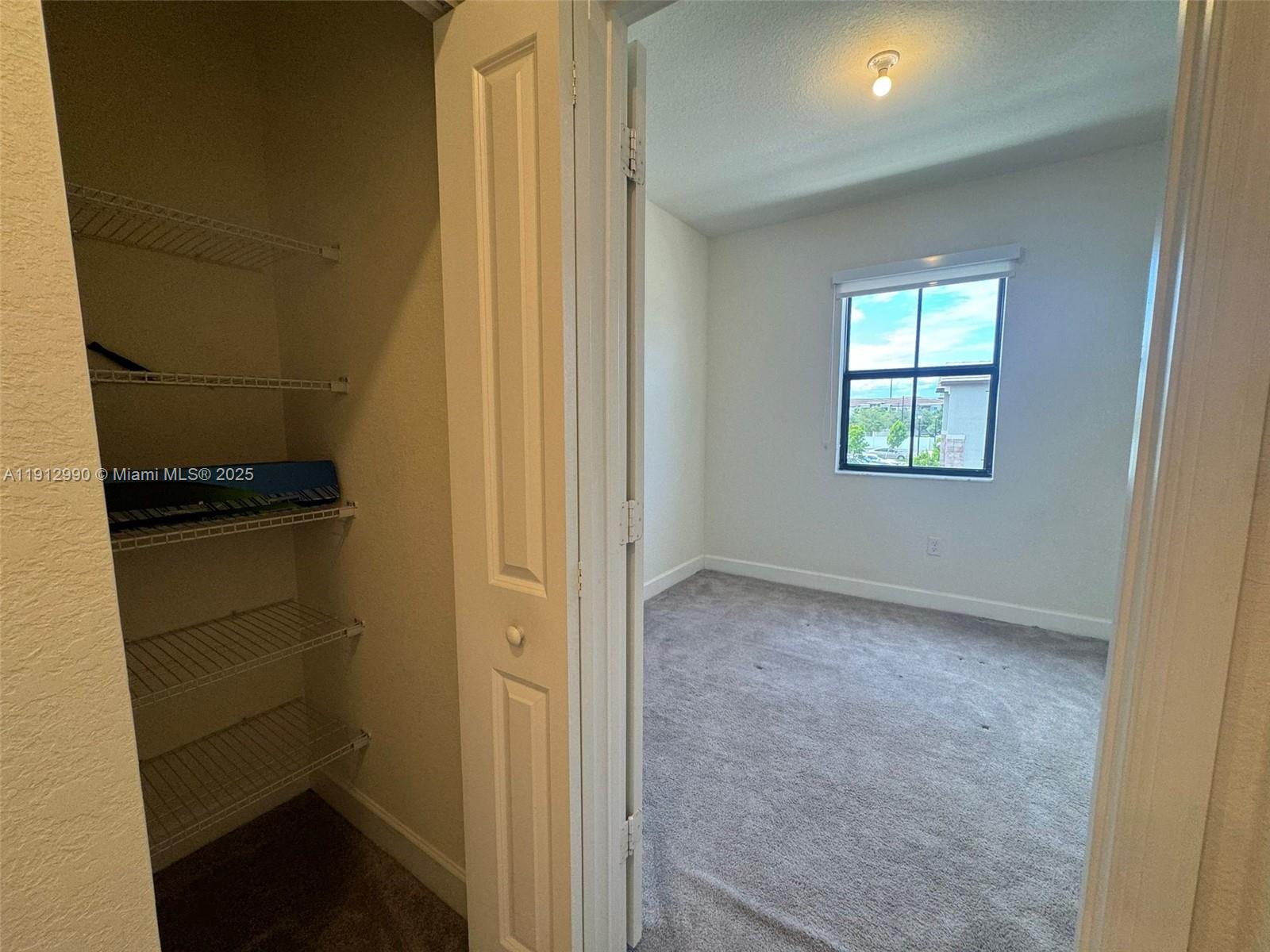 11325 West 34th Way Hialeah, FL 33018 - Photo 19 of 46 a view of hallway with closet and wooden floor