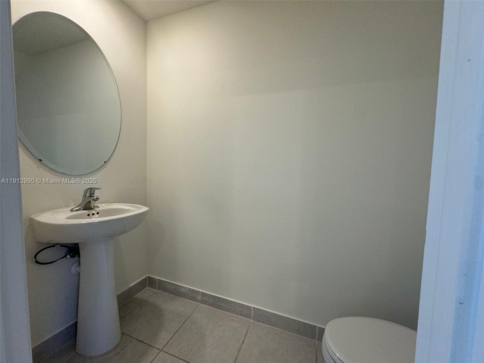 11325 West 34th Way Hialeah, FL 33018 - Photo 36 of 46 a bathroom with a sink toilet and mirror