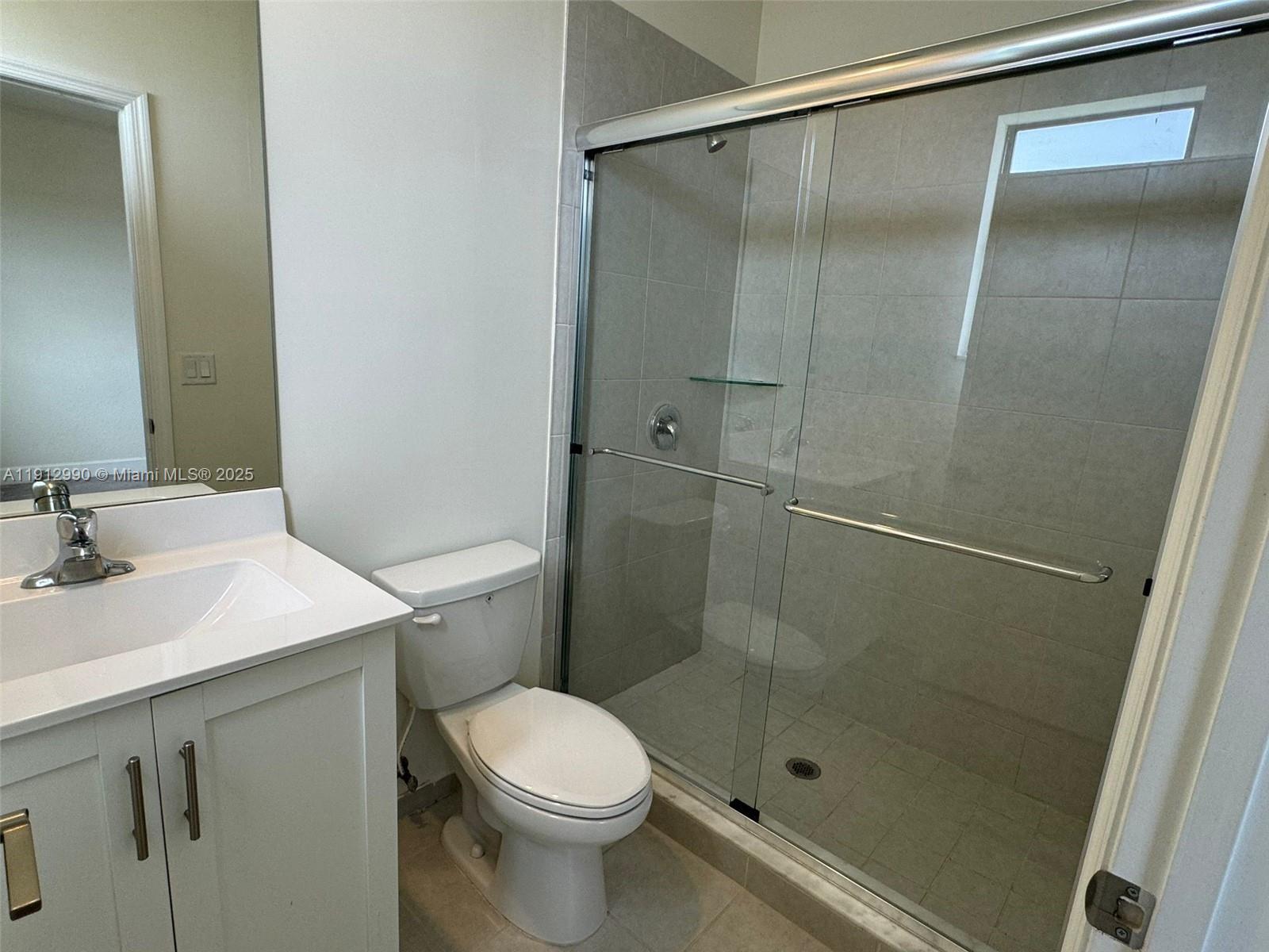 11325 West 34th Way Hialeah, FL 33018 - Photo 40 of 46 a bathroom with a shower sink vanity and toilet