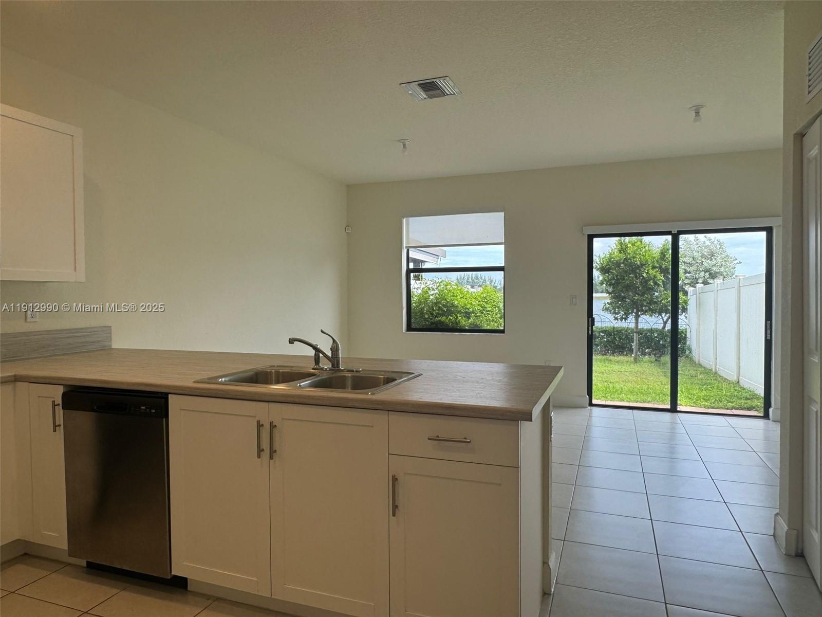 11325 West 34th Way Hialeah, FL 33018 - Photo 10 of 46 a kitchen with a sink and a window