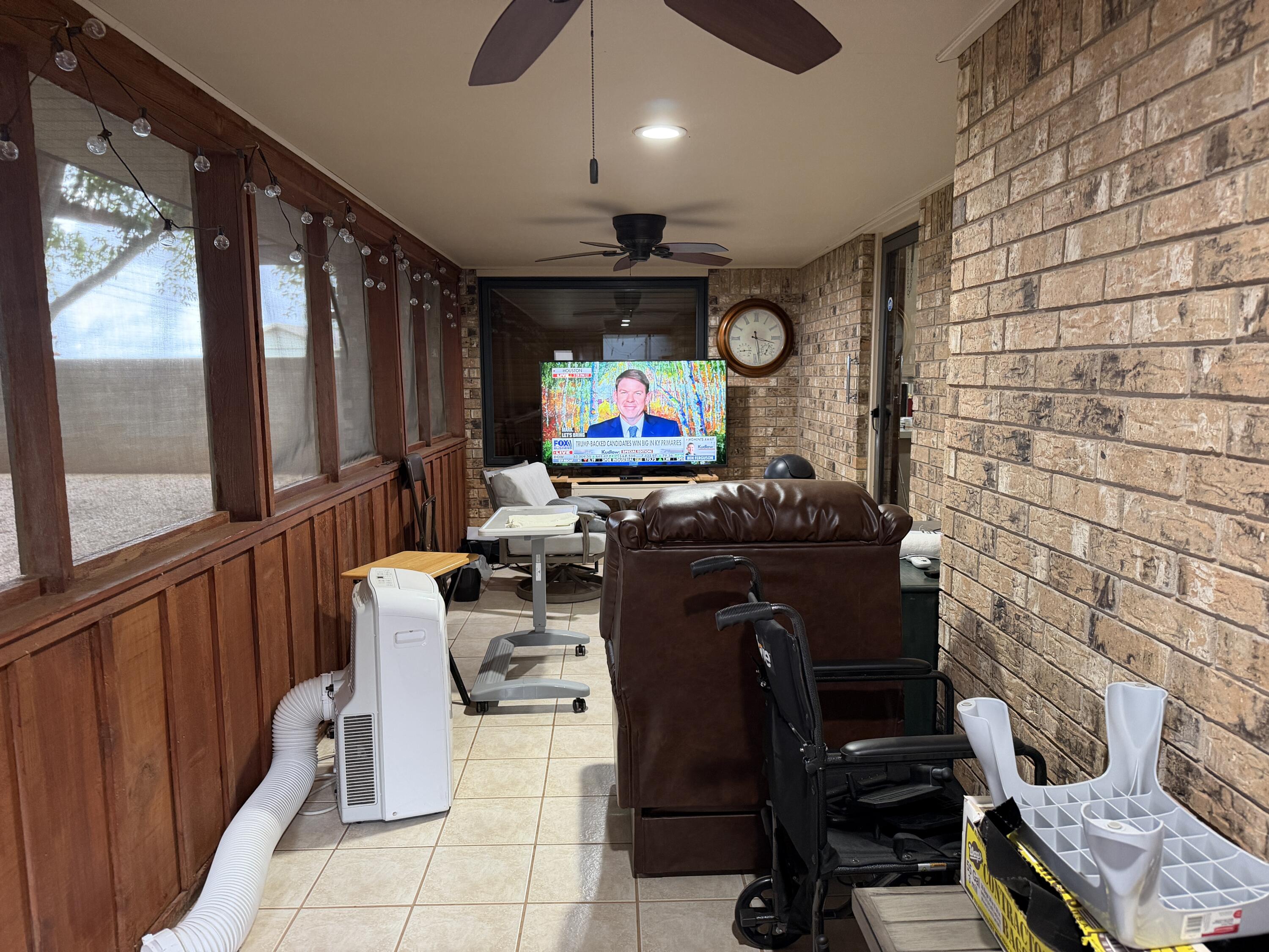 1603 South 8th Street Lamesa, TX 79331 - Photo 28 of 39 a living room with furniture a flat screen tv and floor to ceiling window