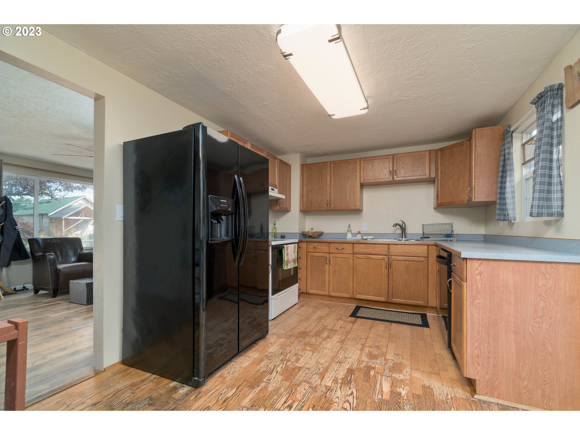 535 West M Street Springfield, OR 97477 - Photo 16 of 48 a kitchen with granite countertop a refrigerator and a sink
