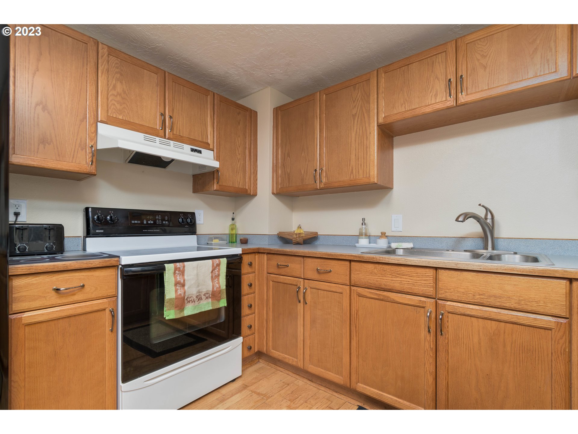535 West M Street Springfield, OR 97477 - Photo 18 of 48 a kitchen with stainless steel appliances granite countertop a stove a sink and a microwave