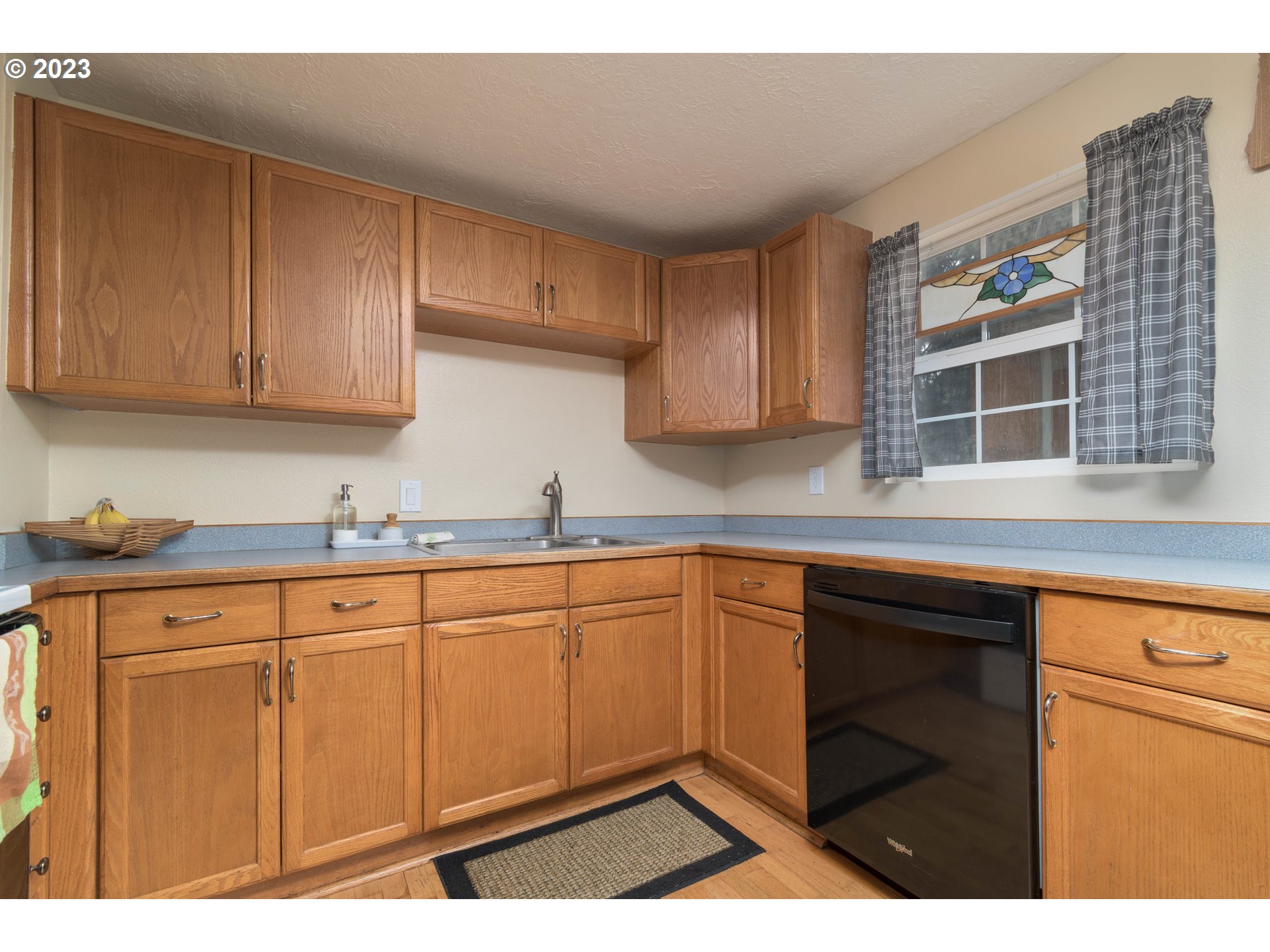 535 West M Street Springfield, OR 97477 - Photo 19 of 48 a kitchen with stainless steel appliances granite countertop a sink and cabinets
