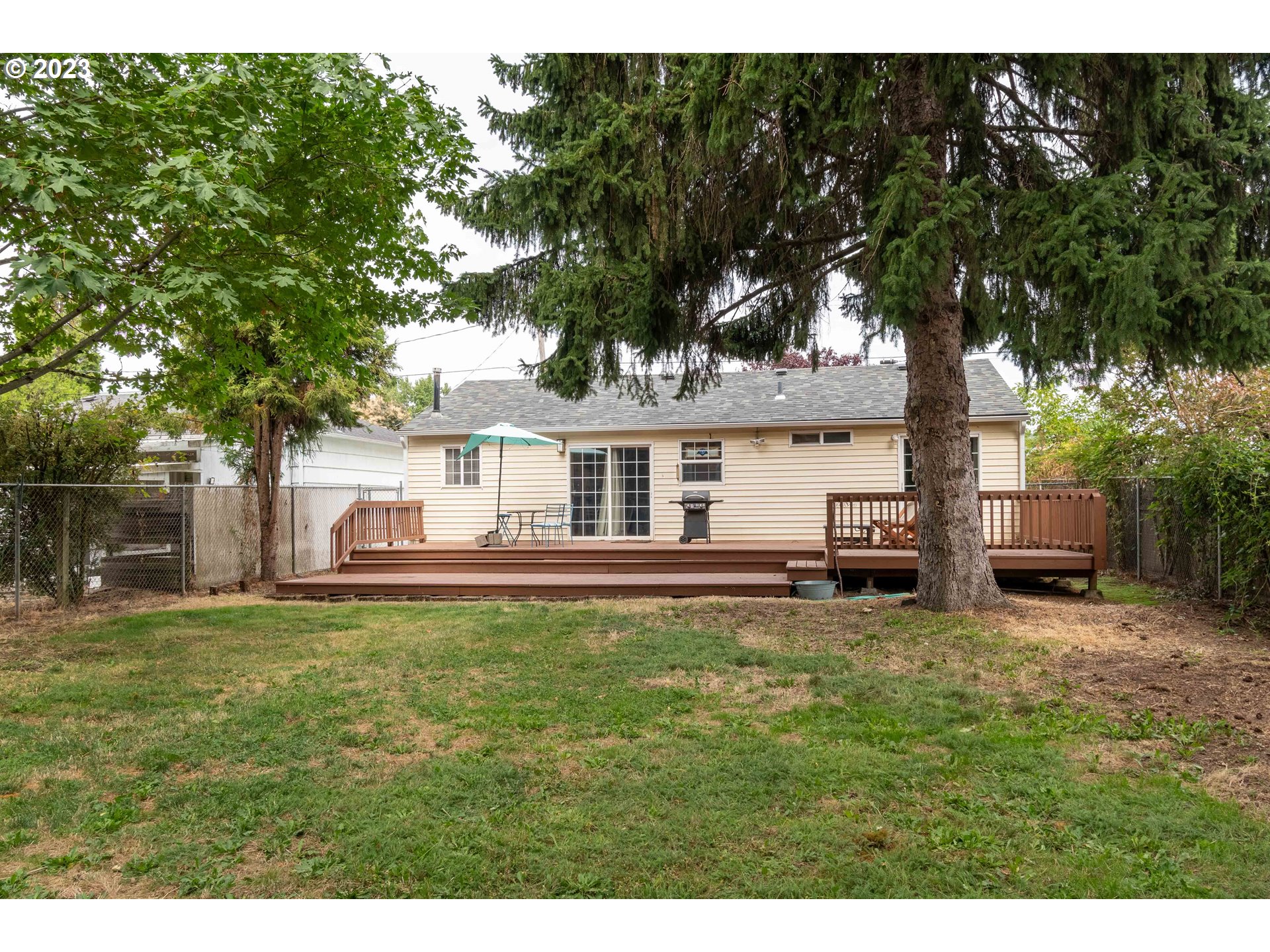 535 West M Street Springfield, OR 97477 - Photo 34 of 48 a view of a house with backyard porch and sitting area