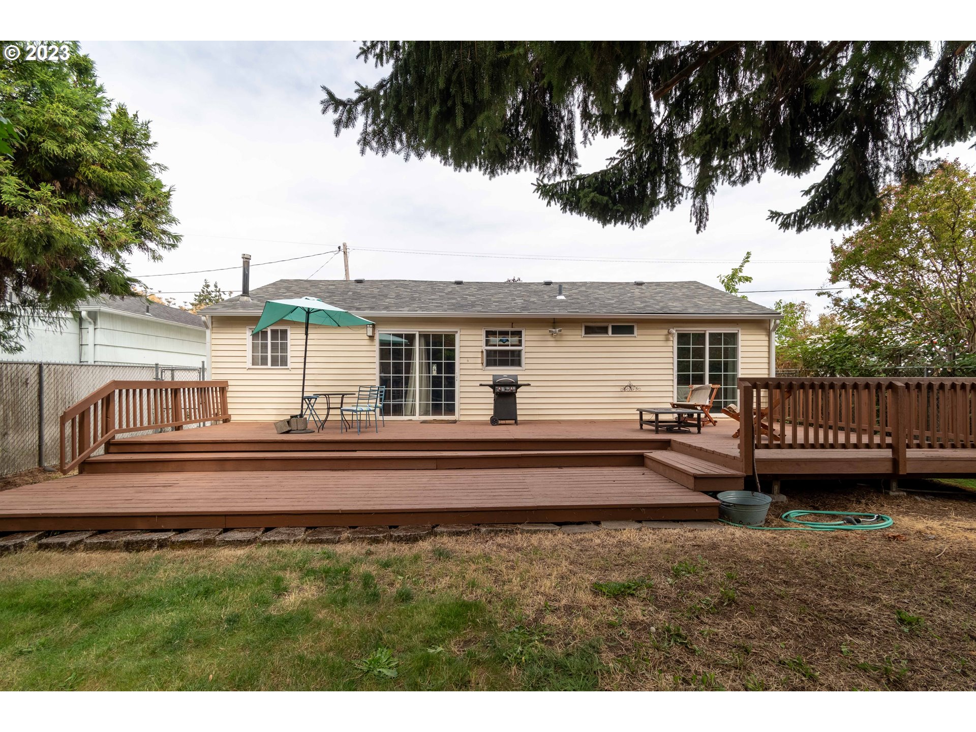 535 West M Street Springfield, OR 97477 - Photo 36 of 48 a view of a house with a backyard and a deck