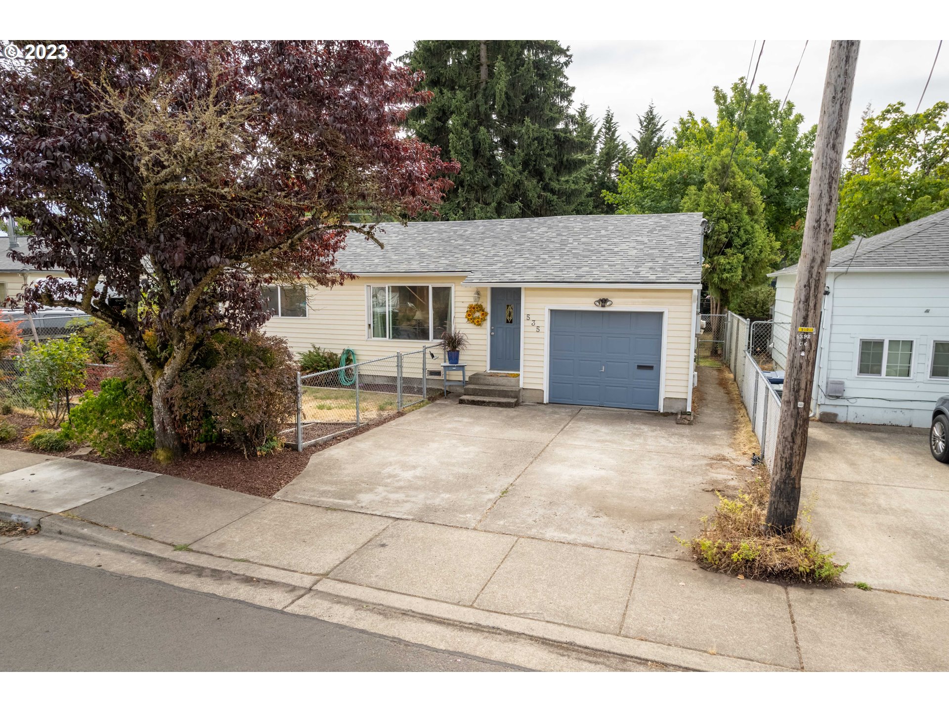 535 West M Street Springfield, OR 97477 - Photo 38 of 48 a view of a house with a yard and garage