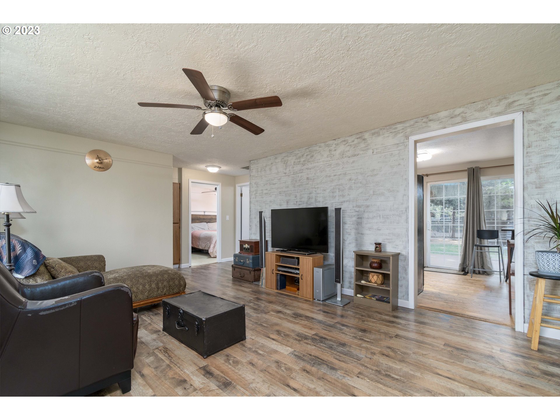 535 West M Street Springfield, OR 97477 - Photo 6 of 48 a living room with furniture and a flat screen tv