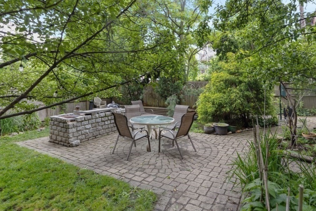 148 Berkshire Street, Unit 4 Cambridge, MA 02141 - Photo 11 of 17 a backyard of a house with table and chairs