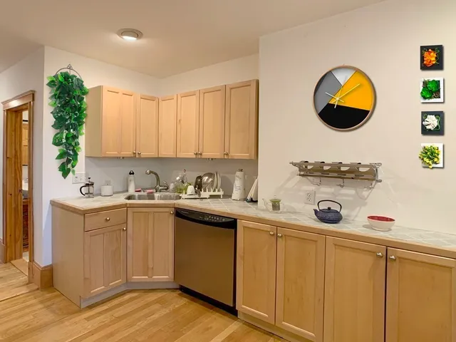 a kitchen with a sink cabinets and a window